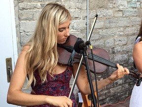 Claire Bouvier performs with an old violin at Pan Chancho Restaurant on Thursday with her Relative bandmates. Bouvier's electric violin and other musical equipment were stolen from her car the day before. (Ian MacAlpine/The Whig-Standard)