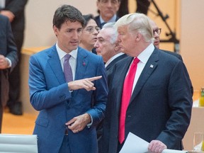 Prime Minister Justin Trudeau (left) speaks to U.S. President Donald Trump at the G20 summit in Hamburg, Germany, on Saturday, July 8, 2017. (Ryan Remiorz/The Canadian Press)