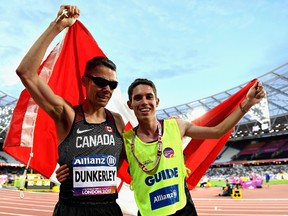 Jason Dunkerley of Ottawa and his guide, Nathaniel Jeremie Venne, celebrate after finishing second in the men's 1,500-metre T11 final in the world para athletics championships at London on Friday.