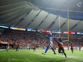 Winnipeg Blue Bombers' Darvin Adams, left, makes a one-handed catch in the end zone to score a touchdown as B.C. Lions' T.J. Lee (6) defends during the second half of a CFL football game in Vancouver, B.C., on Friday July 21, 2017. THE CANADIAN PRESS/Darryl Dyck