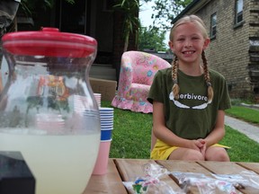 Jane Holman, 9, will be donating the proceeds from her OEV Day lemonade stand to Esther the Wonder Pig. (CHARLIE PINKERTON/London Free Press/Postmedia Network)