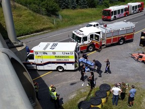 A patient is loaded into an ambulance following a single-vehicle rollover on Highway 174 near Orléans Boulevard Saturday afternoon. 
Vincent Charon photo