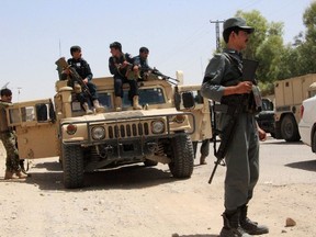 Afghan security personnel sit on atop an armoured vehicles amid an ongoing battle with Taliban militants in the Gereshk district of Helmand province on July 22, 2017. A US airstrike has killed 16 policemen in Afghanistan, officials said July 22, the latest setback to Washington's efforts to bring peace to the war-torn country. The incident took place in Helmand province on Friday as Afghan security forces attempted to clear a village of Taliban militants, Salam Afghan, a police spokesman, told AFP. (NOOR MOHAMMAD/AFP/Getty Images)