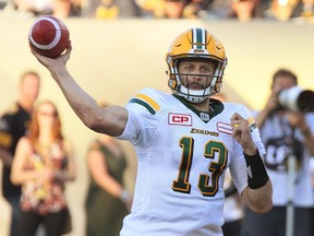 Edmonton Eskimos' quarterback Mike Reilly throws a pass during first half CFL football action against the Hamilton Tiger-Cats in Hamilton, Ont., on Thursday, July 20, 2017.