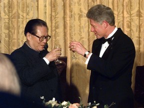 In this Oct. 29, 1997, file photo, U.S. President Bill Clinton and Chinese President Jiang Zemin toast during their state dinner at the White House. (AP Photo/Greg Gibson, File)