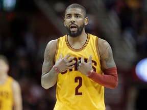 In this Feb. 27, 2017, file photo, Cleveland Cavaliers' Kyrie Irving talks with a teammate in the first half of an NBA basketball game against the Milwaukee Bucks in Cleveland. (AP Photo/Tony Dejak, File)