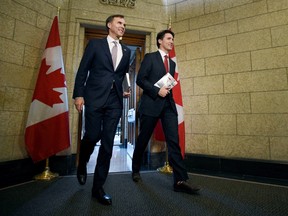 Finance Minister Bill Morneau and Prime Minister Justin Trudeau leave the Prime Minister's office holding copies of the federal budget in Ottawa, Wednesday, March 22, 2017. THE CANADIAN PRESS/Sean Kilpatrick
