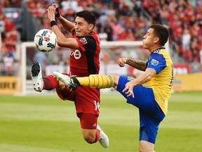 Toronto FC midfielder Marco Delgado (18) and Colorado Rapids midfielder Dillon Serna (17) battle for the ball during first half MLS soccer action in Toronto on Saturday, July 22, 2017. (THE CANADIAN PRESS/Nathan Denette)