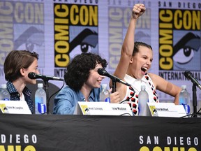 Millie Bobby Brown, right, gestures as from left, Noah Schnapp, and Finn Wolfhard look on at the "Stranger Things" panel on day three of Comic-Con International on Saturday, July 22, 2017, in San Diego. (Photo by Richard Shotwell/Invision/AP)