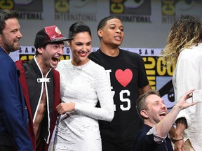 Moderator Chris Hardwick, foreground right, takes a selfie with from left, Ben Affleck, Ezra Miller, Gal Gadot, and Ray Fisher at the Warner Bros. "Justice League" panel on day three of Comic-Con International on Saturday, July 22, 2017, in San Diego. (Photo by Richard Shotwell/Invision/AP)