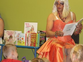 Mz. Affra-Tighty (Katu Azzya) reads to Nolan Hollingsworth (left) and about 150 others while dressed in drag at the London Public Library on Saturday. (Charlie Pinkerton/The London Free Press/Postmedia Network)