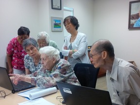 Isabella Dryden (centre) is surrounded by her students. Soon to be 100 years old, the retired teacher from Winnipeg volunteers four times a week, teaching computer technology to seniors at Creative Retirement Manitoba and the Winnipeg Chinese Cultural and Community Centre in Winnipeg. Though Dryden doesn’t turn 100 until October, the City of Winnipeg is surprising her by celebrating her birthday and service to the community on Monday by awarding her with a Community Service Award, which she will be given by Mayor Brian Bowman. MALINDA LEE/Submitted photo