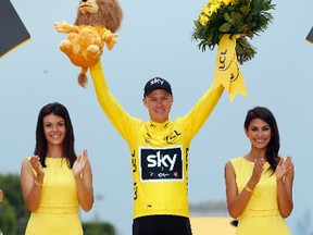 Tour de France winner Britain's Chris Froome, wearing the overall leader's yellow jersey, celebrates on the podium after the twenty-first and last stage of the Tour de France cycling race over 103 kilometers (64 miles) with start in Montgeron and finish in Paris, France, Sunday, July 23, 2017. (AP Photo/Thibault Camus)