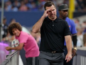 Toronto FC head coach Greg Vanney makes a saluting gesture to fans as he walks off the field after receiving a red card and was sent off in the second half of an MLS soccer game against the New York City FC, Wednesday, July 19, 2017, in New York. The game ended in a 2-2 tie. (AP Photo/Julie Jacobson)