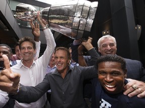 Derrell "Mookie Mitchell, Mike Morreale, Paul Masotti, Doug Flutie, Pierre Vercheval, Michael "Pinball Clemons, and Jeremy O'Day, re-enact the celebrations as the Toronto Argonauts 1996-1997 Grey Cup Teams Reunion was held at the Keg in Toronto, Ont. on Sunday July 23, 2017. (Stan Behal/Toronto Sun/Postmedia Network)