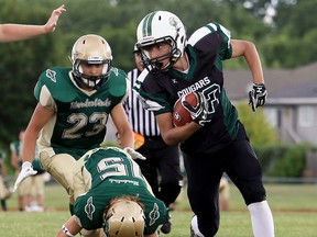 Chatham-Kent Cougars' Nakoma Scott eludes Forest City Thunderbirds' Ryan Asher (15) and Miguel Huette (23) in the first half of a South Division semifinal in the Ontario Football Conference junior varsity playoffs at the Chatham-Kent Community Athletic Complex on Saturday, July 22, 2017. The Cougars won 36-2. (MARK MALONE/The Daily News)