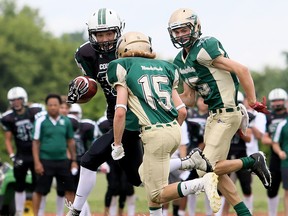 Chatham-Kent Cougars' Nakoma Scott is pursued by Forest City Thunderbirds' Ryan Asher (15) and Brandon Lamoureux in the first half of a South Division semifinal in the Ontario Football Conference junior varsity playoffs at the Chatham-Kent Community Athletic Complex on Saturday, July 22, 2017. (MARK MALONE/The Daily News)