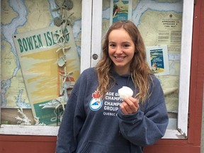Emily Epp, 17, holds a shell she found on her swim around Bowen Island, B.C. on Saturday June 17, 2017 in this photo provided by the Epp family. It took nearly 11 hours, but a 17-year-old girl from Kelowna, B.C., has completed her gruelling goal of swimming around an island off the coast of Vancouver.Instead of resting, Epp is now reaching for another milestone - she plans to swim across the English Channel next month and she's raising thousands of dollars for a children's hospice in the process. (THE CANADIAN PRESS/HO)