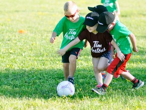 McKenna Schoonderwoerd (middle) appears to be using her arms to slow down opponents Carter Murray (left) and Jase Van Nynatten from reaching the soccer ball during recent Blastball action at Keterson Park. The Wednesday night ritual – where youngsters split their time playing baseball and soccer – has been taking place since late May and concludes tonight (July 26), with the kids showing great improvement over the course of the season. ANDY BADER/MITCHELL ADVOCATE