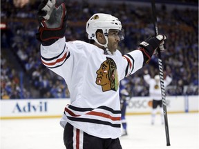 Chicago Blackhawks' Johnny Oduya, of Sweden, celebrates after scoring during the first period in Game 1 of a first-round NHL hockey Stanley Cup playoff series against the St. Louis Blues on Thursday, April 17, 2014, in St. Louis. (AP Photo/Jeff Roberson)