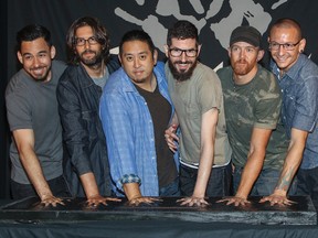 In this June 18, 2014 file photo, members of Linkin Park, from left, Mike Shinoda, Rob Bourdon, Joe Hahn, Brad Delson, Dave Farrell and Chester Bennington attend an induction ceremony for the Guitar Center's RockWalk at Guitar Center in Los Angeles. Linkin Park said their hearts are broken following the death of Bennington, who died by hanging last week. The rock band said Monday, July 24, 2017, the “shockwaves of grief and denial are still sweeping through our family as we come to grips with what has happened.” (Photo by Paul A. Hebert/Invision/AP, File)