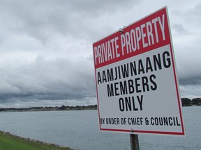 Aamjiwnaang First Nation has posted private property signs along its river front in response to increased use by non-members leading to issues with littering, damage by vehicles and overcrowding on its docks. 
(Paul Morden/Sarnia Observer)