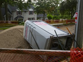 Vandals spray painted and tipped over a portable toilet at a road construction site on St. George St. in London, Ont. on Sunday July 23, 2017.  (DEREK RUTTAN, The London Free Press)