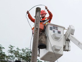 Taylor Bertelink/The Intelligencer
Tal Trees Power Services employee Colin Mercier changes the street lights to more efficient LED bulbs along North Front St. on Monday morning.