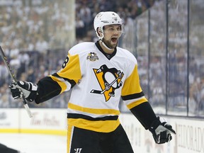 In this April 16, 2017, file photo, Pittsburgh Penguins' Brian Dumoulin celebrates their goal against the Columbus Blue Jackets during the first period in Game 3 of a first-round NHL hockey playoff series, in Columbus, Ohio. (AP Photo/Jay LaPrete, File)