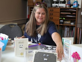 Jason Miller/The Intelligencer
Cindy Renaud, a brain injury survivor, works on gift cards at the Belleville offices of the Brain Injury Association Quinte Branch.