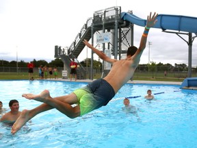 Carson Lumley, 13 aims for the perfect belly flop at Stronach Pool. Lumley was at the pool as part of a summer baseball camp run by the London Badgers. (MIKE HENSEN, The London Free Press)