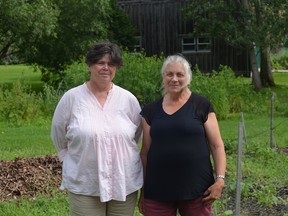 Kathy Sturmey and Tara Kainer, two of many organizers of the Community Harvest Garden, pose in front of the Mother Garden at the Sisters of Providence of Saint Vincent De Paul in Kingston. (Ashley Rhamey/For The Whig-Standard)
