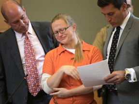Attorneys flank Angelika Graswald, centre, as she cries after pleading guilty to criminally negligent homicide in the kayak-related death of her fiance Vincent Viafore, Monday, July 24, 2017, in Orange County court in Goshen, N.Y. Graswald, who was accused of intentionally drowning her fiance in the Hudson River by tampering with his kayak, pleaded guilty on Monday to a lesser charge that could minimize the amount of additional time she spends in jail. (Allyse Pulliam/Times Herald-Record via AP, Pool)