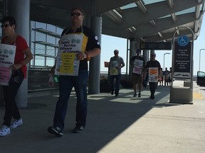 Striking Winnipeg Airport Authority workers walk the picket line at Winnipeg's Richardson International Airport on Monday, July 24, 2017. David Larkins/Winnipeg Sun/Postmedia Network