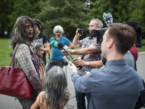 Leanne MacRae, and her daughters Miranda and Juliette talk to reporters after attending a memorial service dressed up as zombies, to pay tribute to zombie film director George Romero, who died at the age of 77, at Mount Pleasant Cemetery in Toronto on Monday, July 24, 2017.  (THE CANADIAN PRESS/PHOTO)