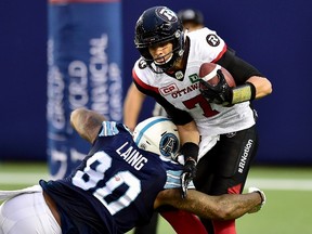 Ottawa Redblacks quarterback Trevor Harris gets sacked by Toronto Argonauts defensive lineman Cleyon Laing during CFL action in Toronto on July 24, 2017. (THE CANADIAN PRESS/Frank Gunn)