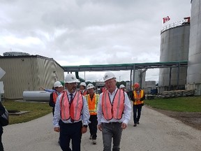 Ontario’s energy minister Glenn Thibeault, left, and IGPC Ethanol’s CEO Jim Grey tour the energy company’s facility in Aylmer on Monday afternoon. (Laura Broadley/Times-Journal)