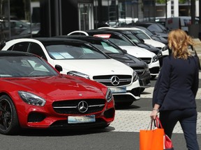A woman walks past Mercedes cars at a dealership on July 13, 2017 in Berlin, Germany.  (Sean Gallup/Getty Images)