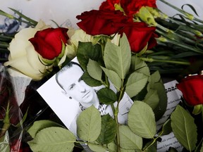 A picture taken on July 22, 2017 shows red roses and a picture of Linkin Park frontman Chester Bennington laid in front of the US embassy in central Moscow in memory of Bennington on July 22, 2017. Linkin Park frontman Chester Bennington killed himself on the birthday of his late friend Chris Cornell of Soundgarden, highlighting the close friendship between the two troubled singers. The 41-year-old Bennington, who like Cornell had long suffered alcohol and drug problems, was found hanging at his Los Angeles home on July 20, 2017. (MAXIM ZMEYEV/AFP/Getty Images)