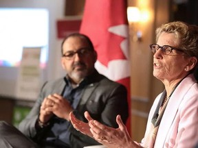 Premier Kathleen Wynne addresses a Greater Sudbury Chamber of Commerce audience in late May, as MPP Glenn Thibeault looks on. The premier said at the time a plan to increase the minimum wage was coming. (Gino Donato/Sudbury Star file photo)