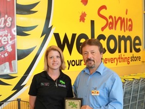 Sarnia Boys & Girls Club program director Lisa Lanouette presented local Giant Tiger owner Leo Suglio with a plaque on July 18, thanking Giant Tiger for a grant that will allow the club to provide French language tutouring and homework help beginning this fall.
CARL HNATYSHYN/SARNIA THIS WEEK