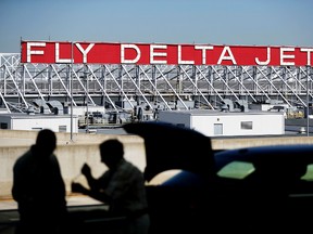 In this Thursday, Oct. 13, 2016, file photo, a Delta Air Lines sign overlooks the unloading area at Hartsfield-Jackson Atlanta International Airport, in Atlanta. On Tuesday, July 25, 2017, (AP Photo/David Goldman, File)