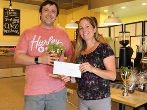 Julie Welker, community partnership specialist with the Upper Thames River Conservation Authority, presents Sean Hunter of Glen Cairn Community Resource Centre with a prize following Adelaide Business in Bloom, a friendly competition among members of the Glen Cairn neighbourhood. (Photo courtesy the Upper Thames River Conservation Authority)