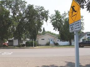 The playground zone sign and the speed limited painted on the road on Centre Street.