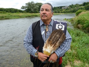Chippewas of the Thames First Nation chief Myeengun Henry stands beside the Thames River. (MORRIS LAMONT, The London Free Press)