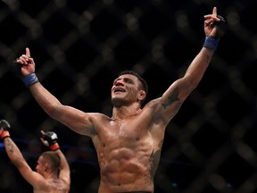 Rafael dos Anjos, right, and Tarec Saffiedine react at the end of their welterweight bout during UFC Singapore Fight Night at Singapore Indoor Stadium on June 17, 2017. (Suhaimi Abdullah/Getty Images)