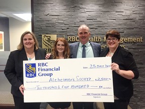 Riding to Remember's Cassandra Cahill, second from left, accepts a donation of $2,500 from RBC Financial Group. RBC King Street branch manager Jennifer Lemieux, left, and Shawn Cahill present the cheque along with Cahill and Lesley Kimble from the Alzheimer Society of KFL&A. (Joseph Cattana/For The Whig-Standard)