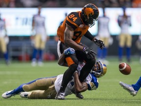 B.C. Lions' Emmanuel Arceneaux, front, drops the ball after catching it while being tackled by Winnipeg Blue Bombers' Brandon Alexander during the first half of a CFL football game in Vancouver, B.C., on Friday July 21, 2017. Winnipeg challenged the reception call on the field and it was overturned and ruled an incomplete pass. THE CANADIAN PRESS/Darryl Dyck