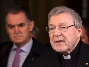In this March 3, 2016 file photo, Australian cardinal George Pell reads a statement to reporters as he leaves the Quirinale hotel in Rome, Italy. (AP Photo/Riccardo De Luca, File)