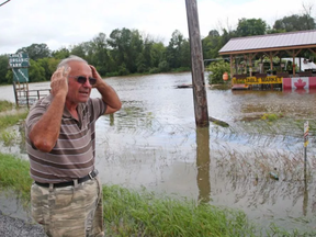 Claudio Cava reacts to the flood affecting his farm in North Gower on Roger Stevens Dr.
